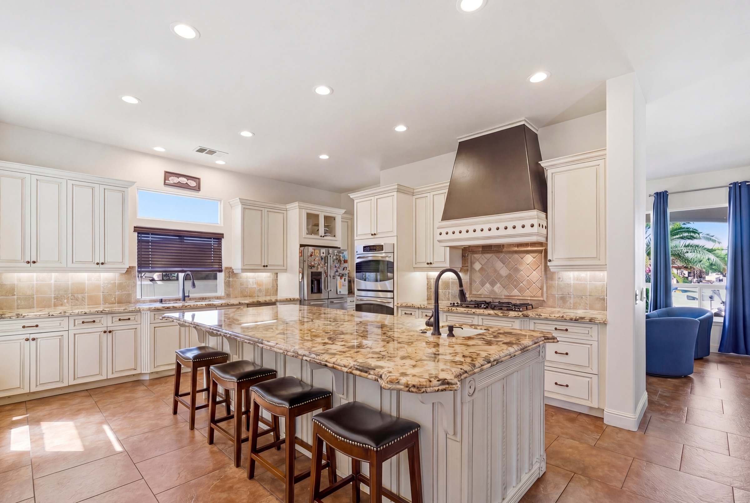 Real estate photography of a chef's kitchen with granite island in Visalia, California