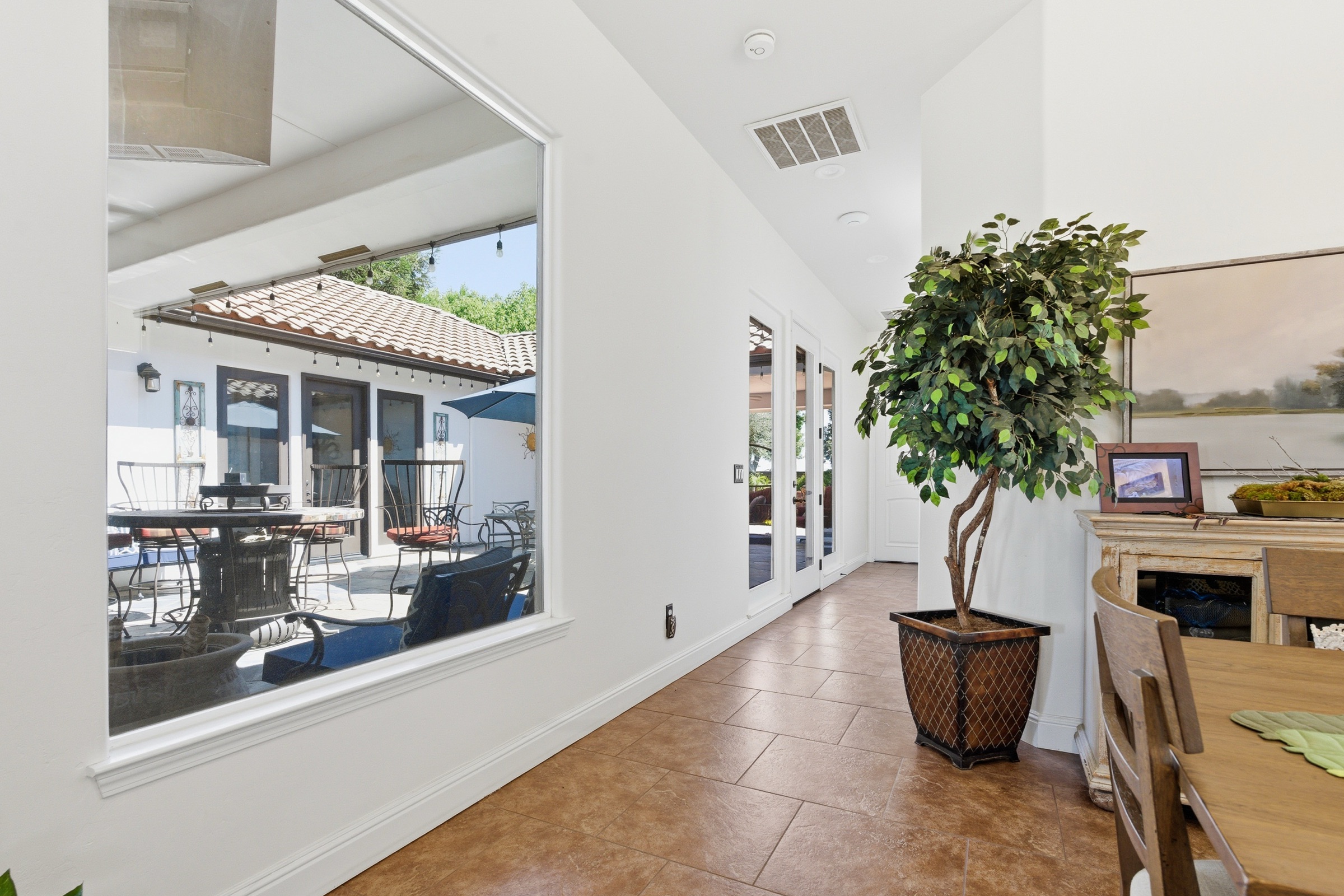 Interior real estate photography of a sunlit breezeway in Visalia, California