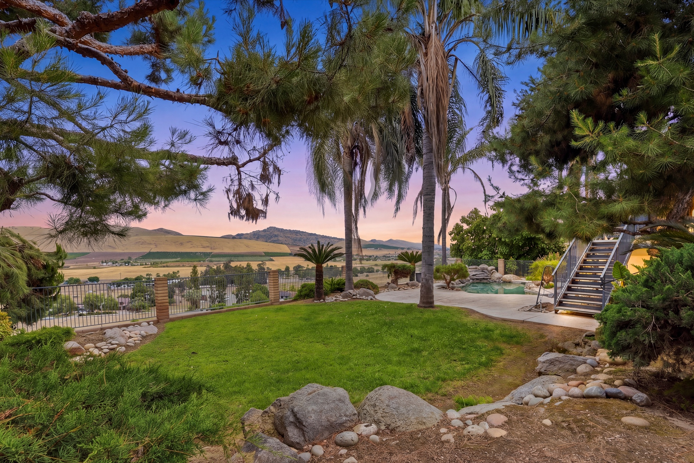 Twilight real estate photography of a hillside home and pool in Porterville, California