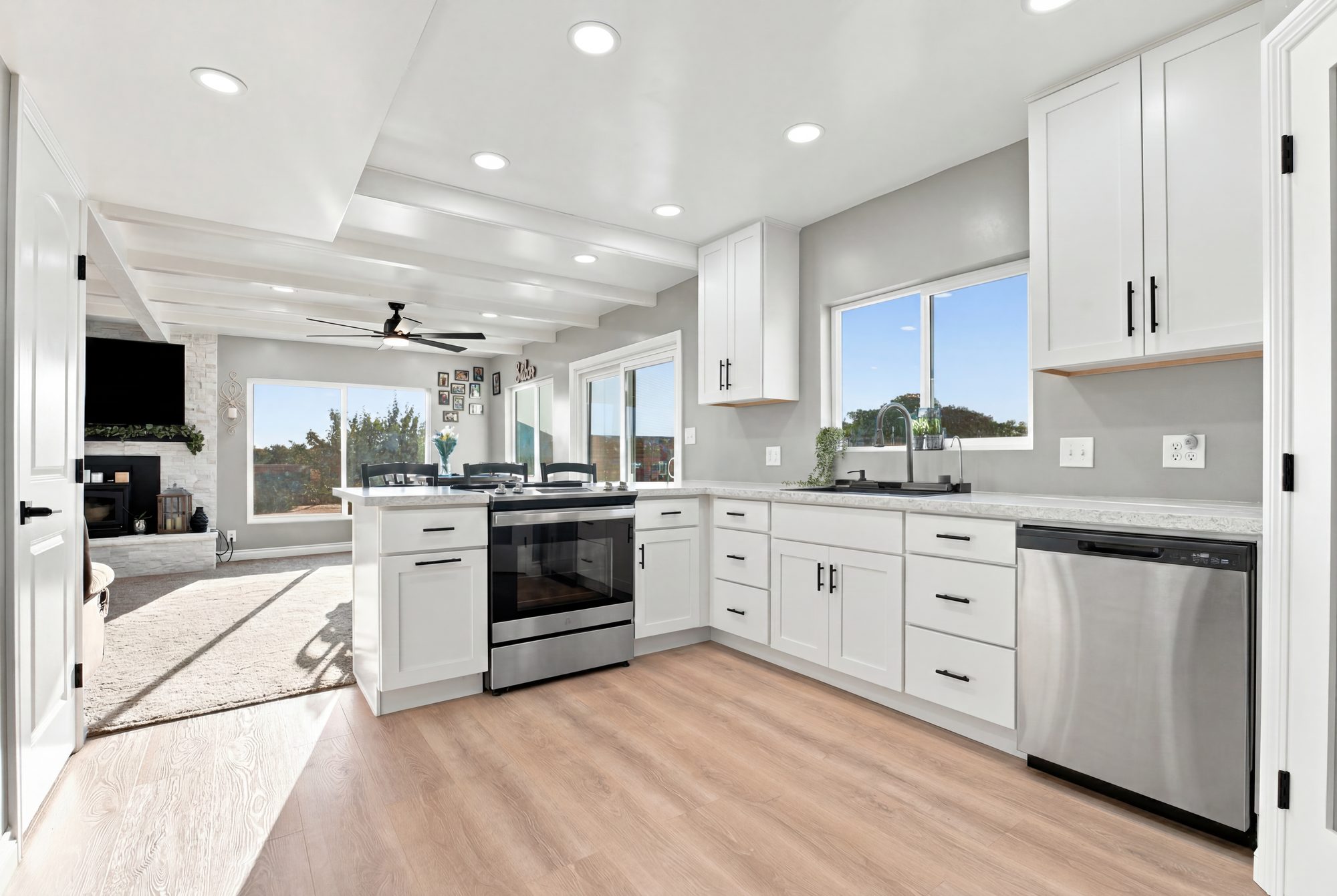 Bright white kitchen with window pull and stainless appliances — Lindsay real estate photography, California