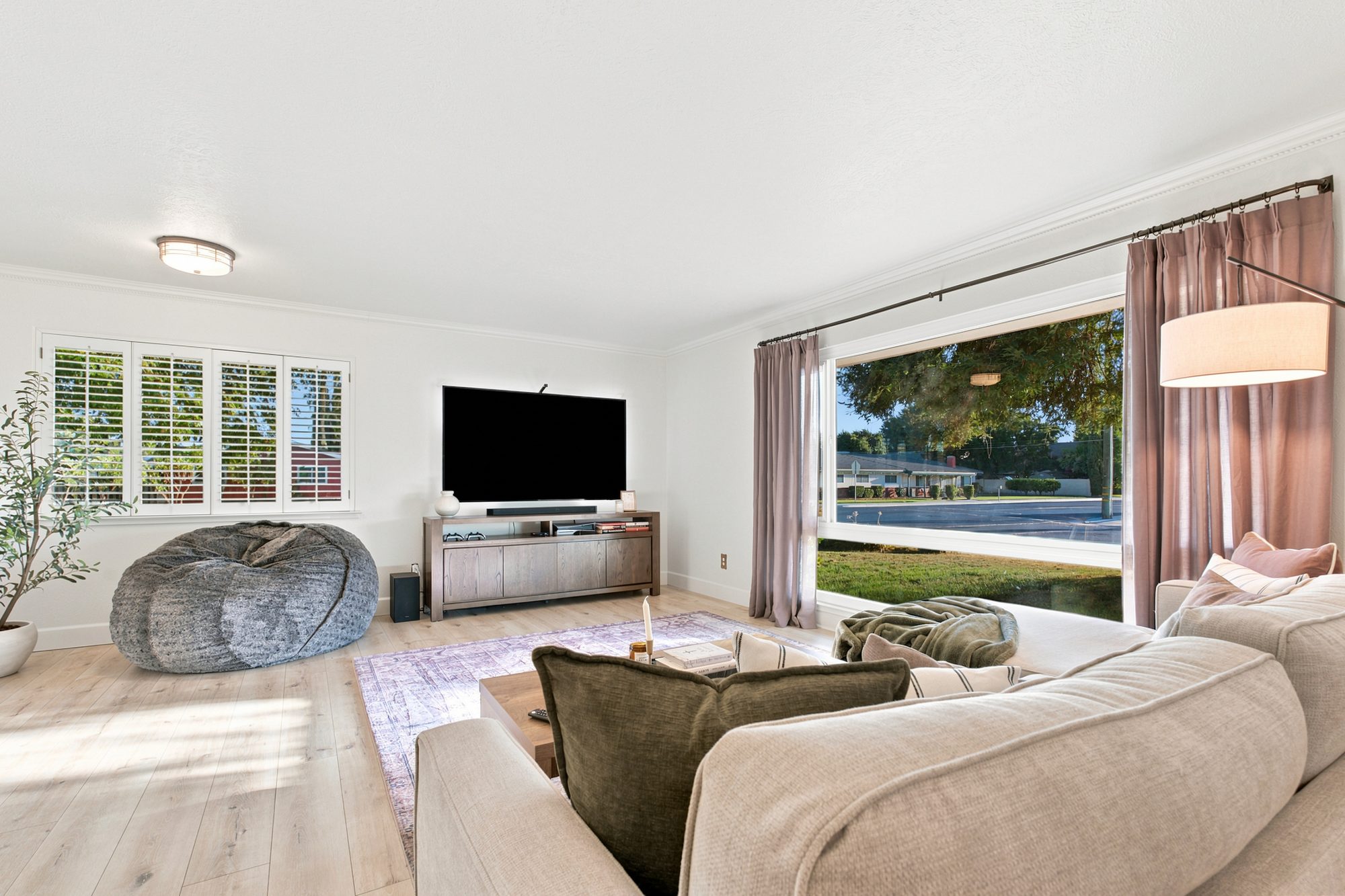 Bright open living room with a large picture window and window pull — Madera real estate photography, California