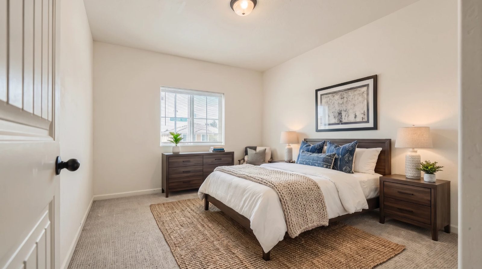 Virtually staged primary bedroom with dresser and window — 4842 W Payson Ave, Visalia, California