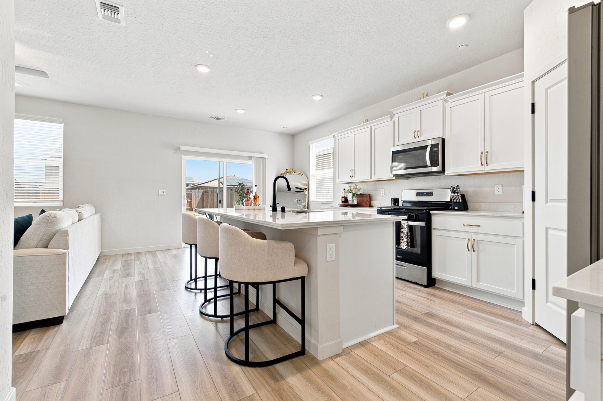 Modern white kitchen with island — Tulare real estate photography, California